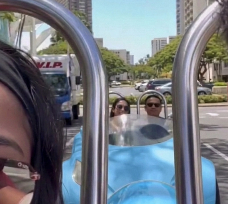 Colorful 3 wheel car ride near Waikiki streets and ocean views